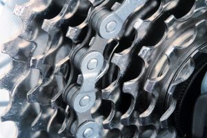 The rear sprocket, gears and chain of a bike.